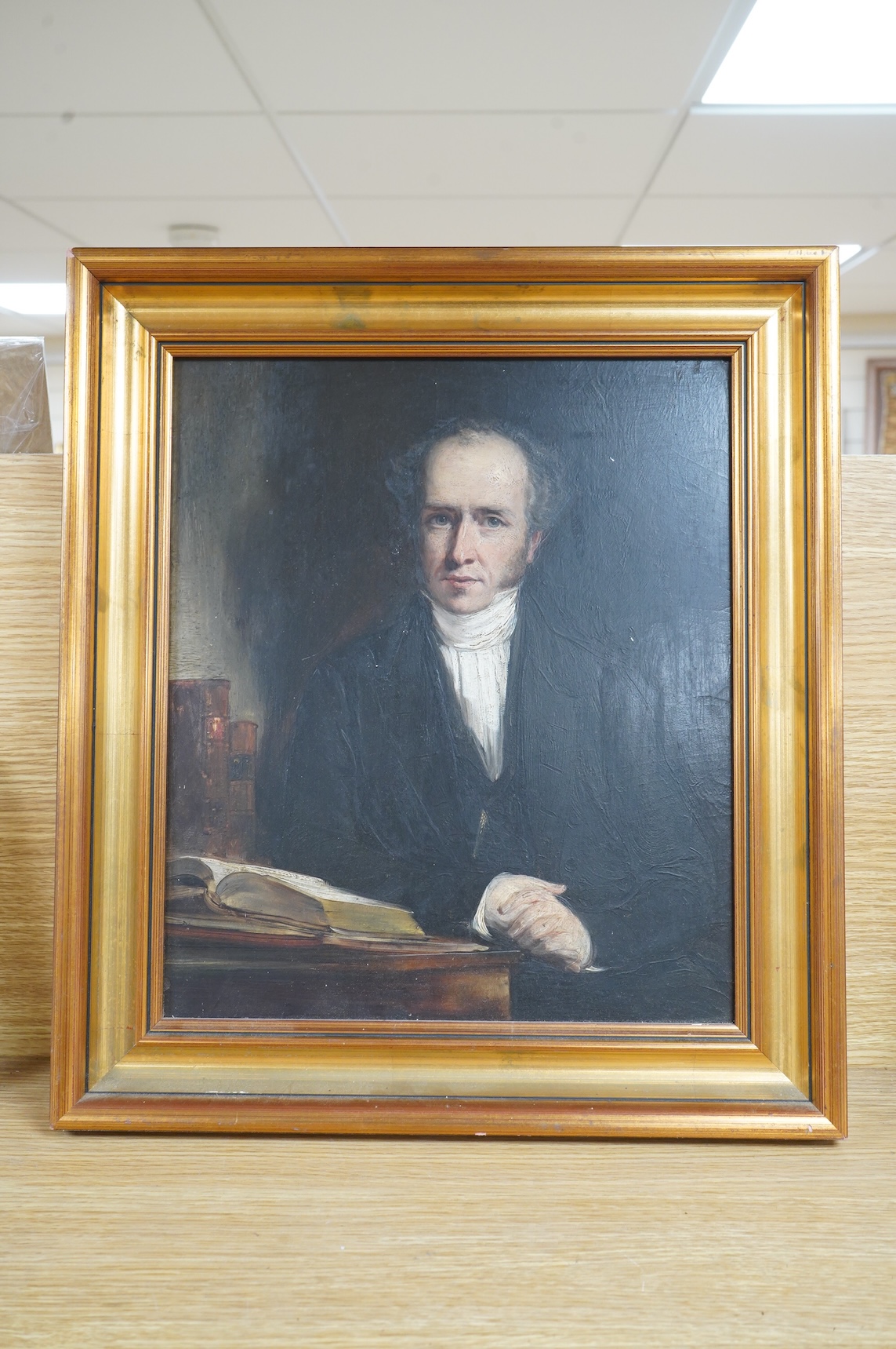 Early 19th century, English School, Portrait of a seated gentleman at a table, oil on board, 34 x 29cm, gilt frame